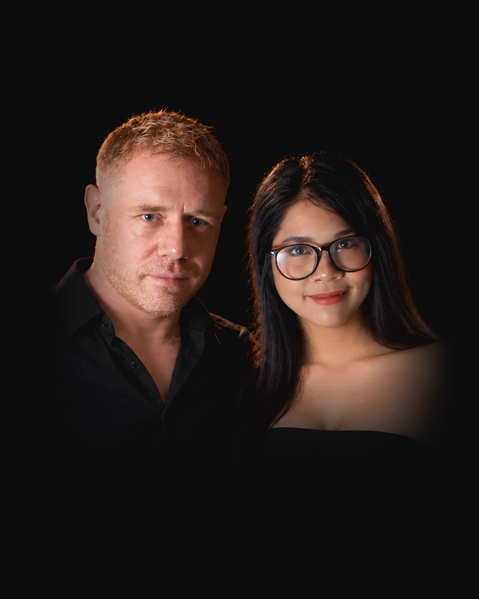 Tim and Paemi, who run PattayaStream, side by side in black.